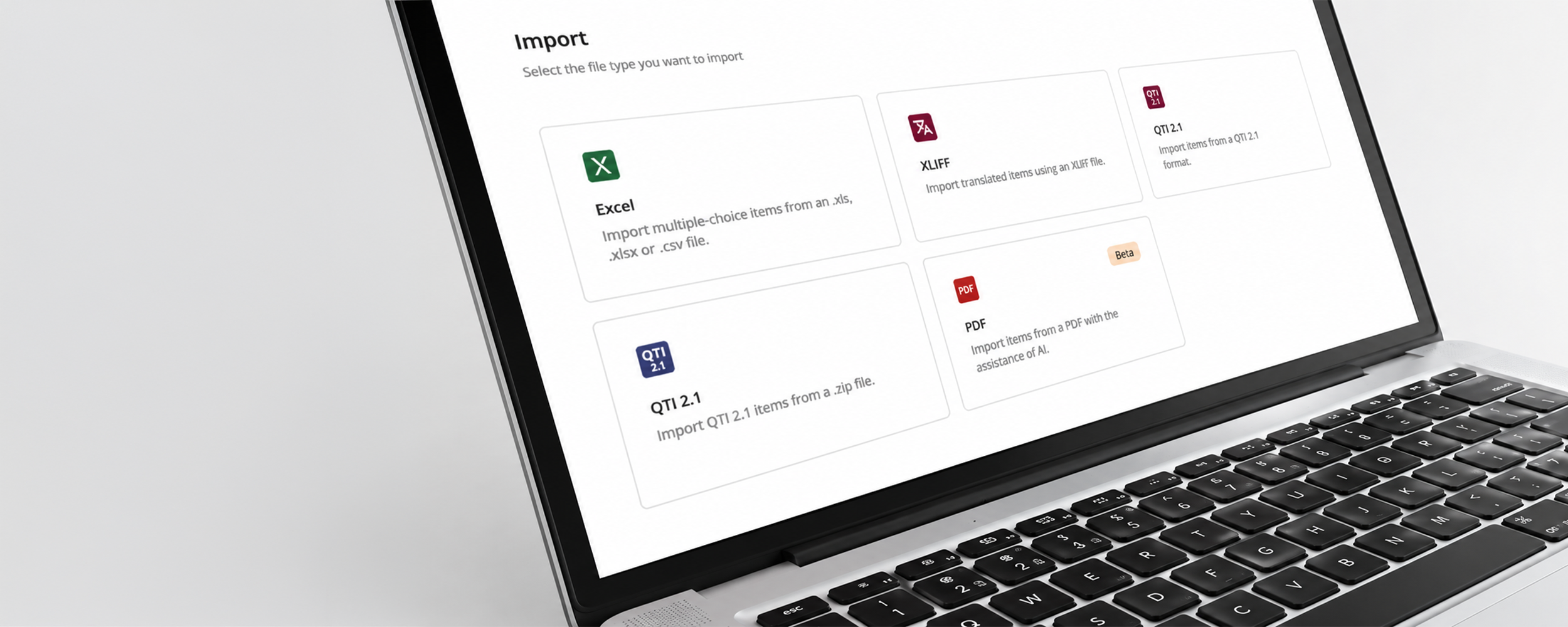 Close-up of a laptop screen displaying an 'Import' interface with five file type options: Excel (import multiple-choice items from .xls, .xlsx, or .csv), XLIFF (import translated items), QTI 2.1 (import items from a QTI 2.1 format or .zip file), and PDF (import items from a PDF with AI assistance, marked as Beta).