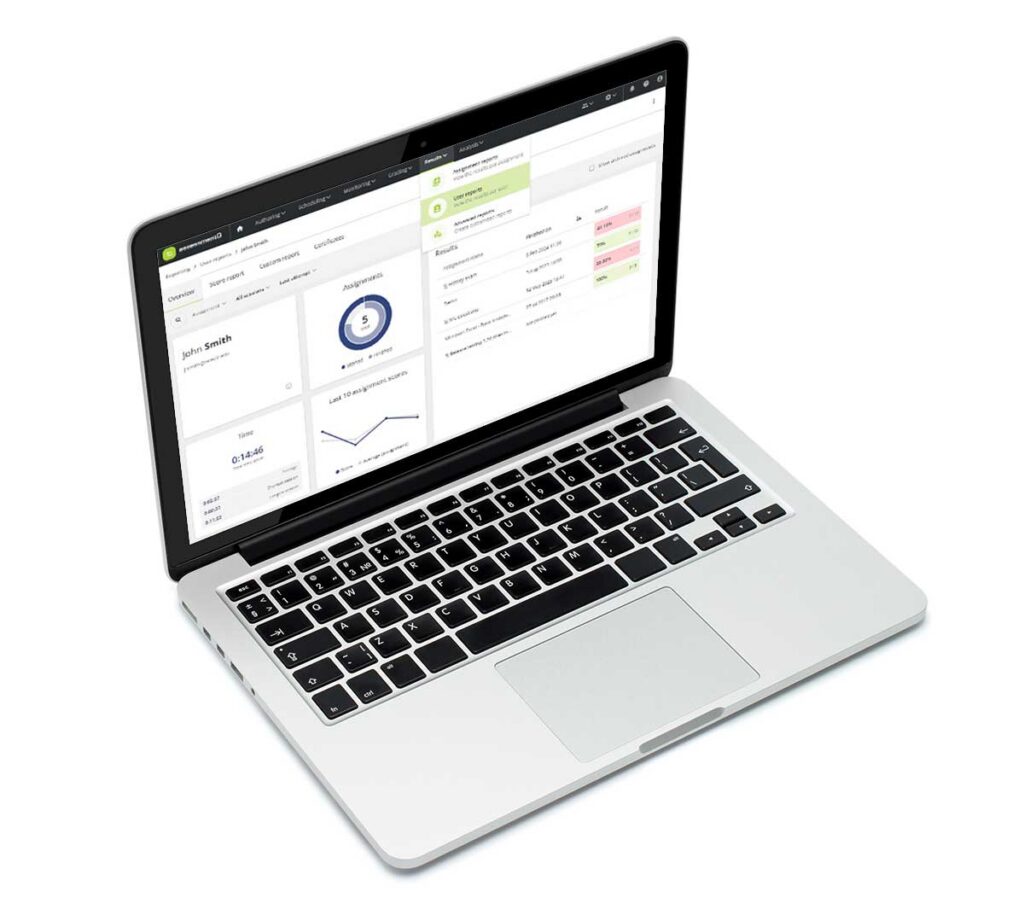 A laptop displaying the assessmentQ platform's reporting dashboard for a user named John Smith, showing assignment results, a donut chart of completed tasks, a line graph of performance over time, and a results table with colour-coded scores in green and red. A dropdown panel showing assignment and user reports is open in the upper right area of the screen.