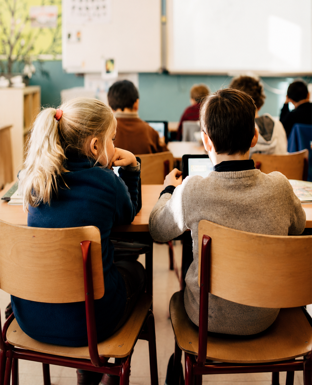 Students in a classroom looking at the digital screen